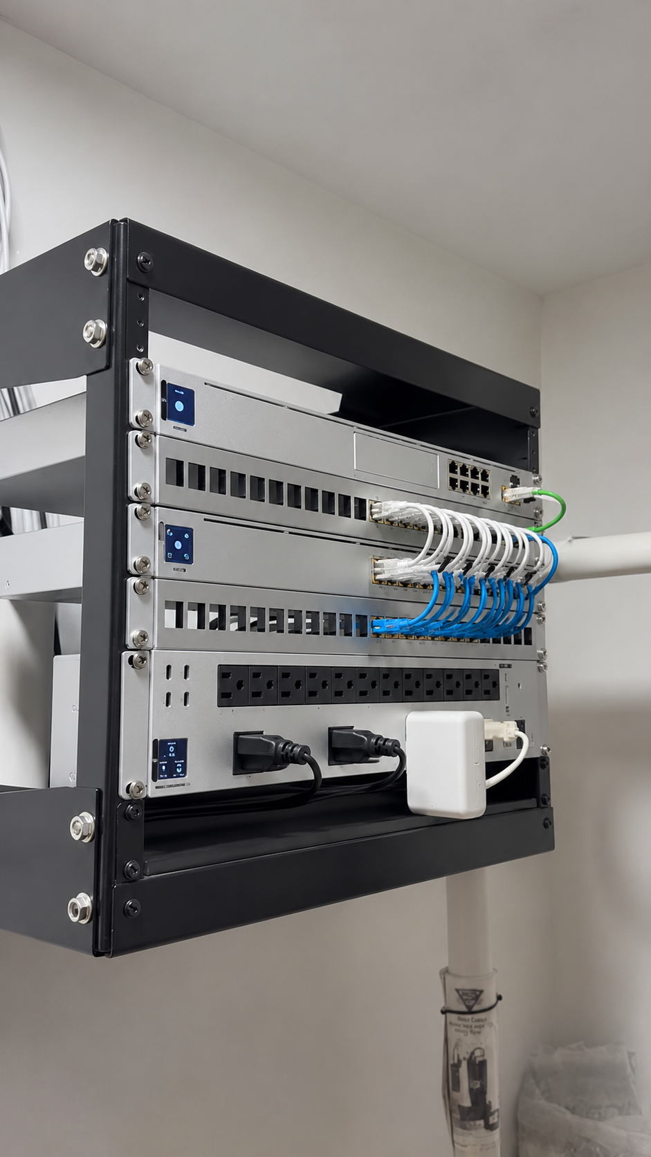 Tidy wall-mounted network rack with labeled cabling